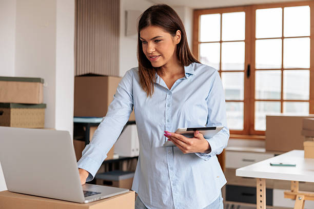 istock Woman Using Laptop and Tablet to Run Her Home Business 2228055359