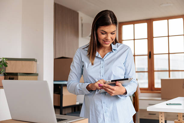 istock Woman Using Laptop and Tablet to Run Her Home Business 2228055449