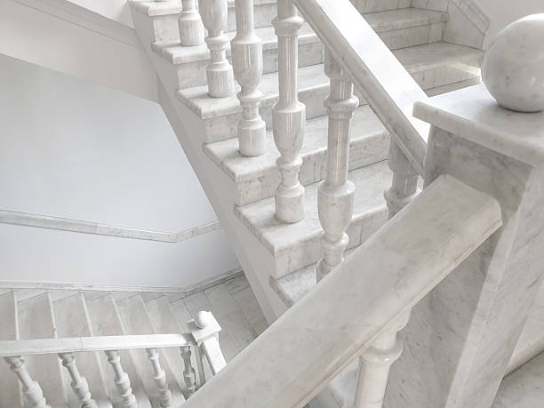 White staircase with marble balusters. Old fashioned marble staircase