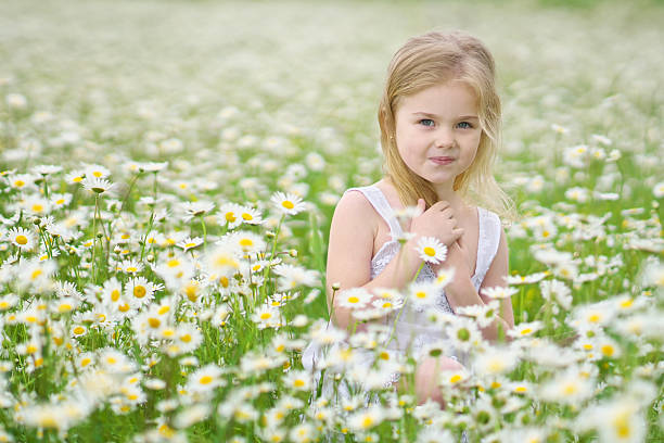 istock Cute little girl in big chamomile meadow 2228058236