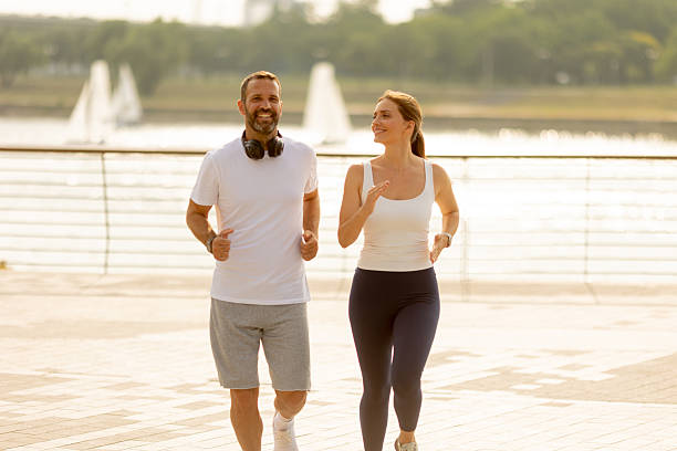 istock Couple enjoying a morning jog by the waterfront on a sunny day 2228061421