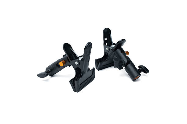 istock Two durable black clamps with orange handles lying side by side, isolated on a white background. 2228062676