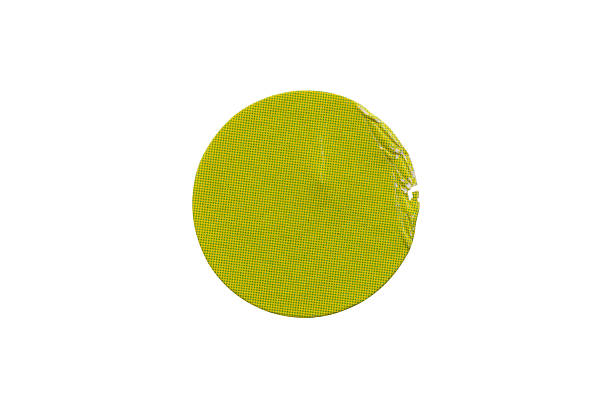 Blank green round adhesive paper sticker label isolated on white background