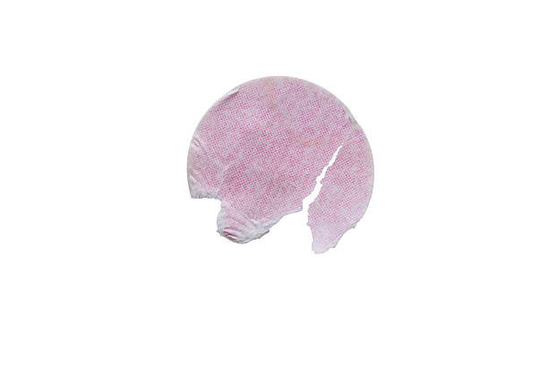 Blank pink round adhesive paper sticker label isolated on white background