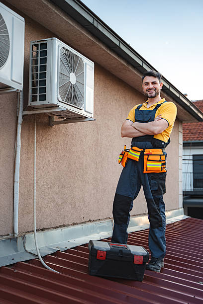 istock Hvac technician posing with arms crossed after installing an air conditioner on a rooftop 2228065294