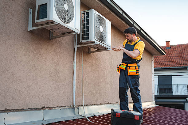 istock Technician installing an air conditioner on the wall of a house 2228065356