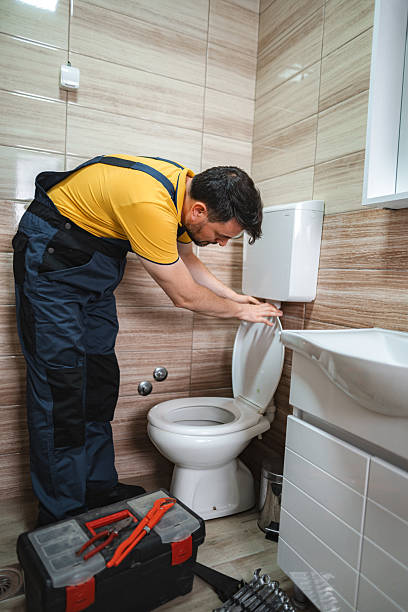 istock Plumber fixing toilet seat in bathroom 2228065388