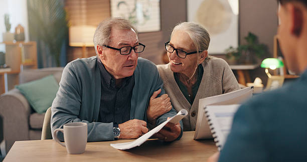istock Senior couple, documents and financial advisor with retirement plan for asset management at house. Elderly man, woman and paperwork with accountant for pension fund or application at old age home 2228065494