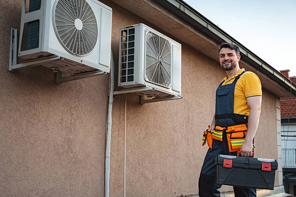 istock Air conditioner technician installing new air conditioners on a wall 2228065561