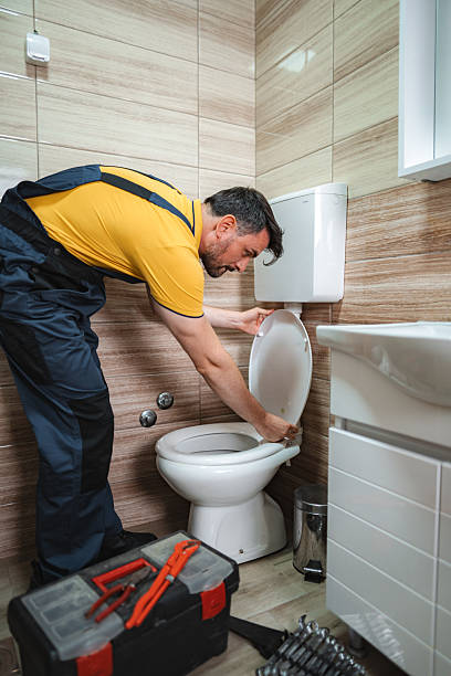 istock Plumber fixing toilet seat in a bathroom 2228065616