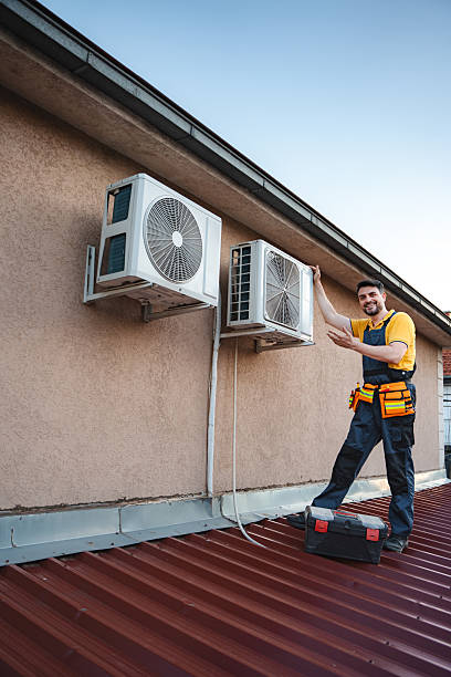 istock HVAC technician installing an air conditioner on a building rooftop 2228065710