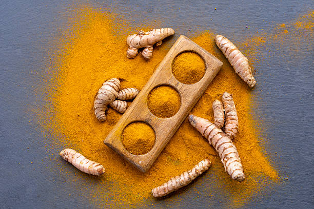 istock Fresh and ground turmeric root on a slate background 2228072967