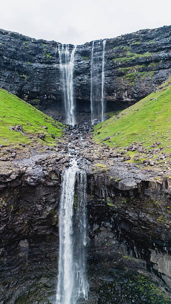 istock Majestic waterfalls cascade down lush cliffs in Faroe Islands breathtaking landscape 2228073328