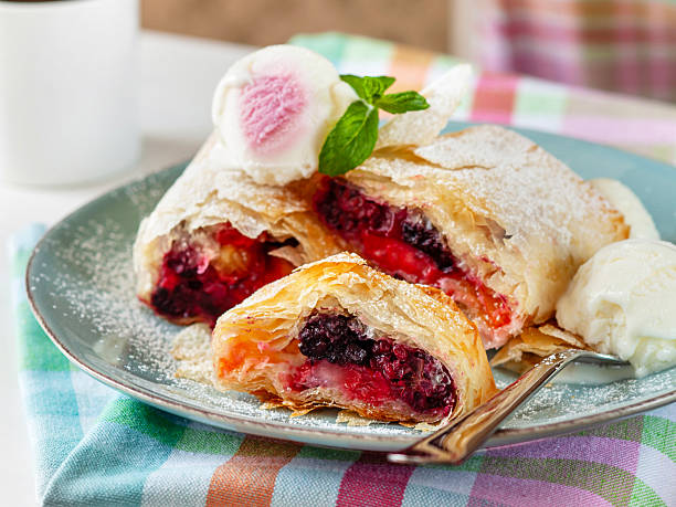 Berry strudel. Berry strudel with ice cream and coffee. Berry Turnover. Forest fruit strudel.