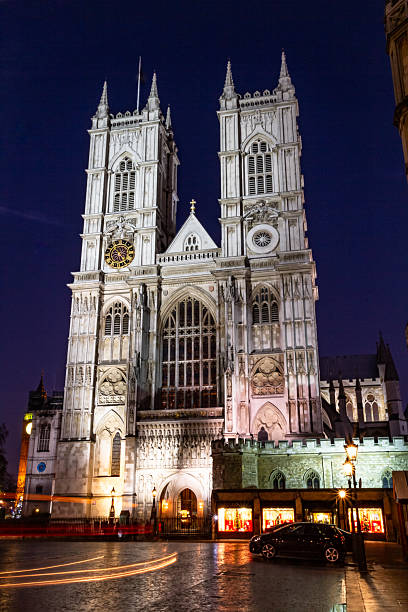 View of the Palace of Westminster building, home to the Houses of Parliament in London illuminated at dusk.