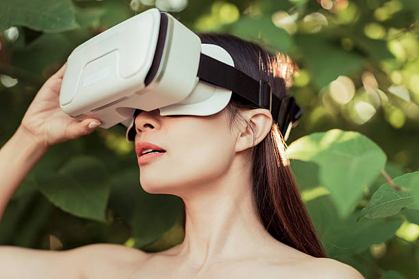 istock Woman wearing a virtual reality headset outdoors 2228080963