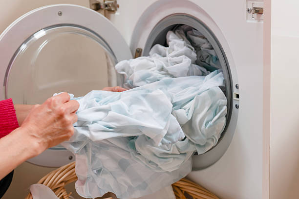 istock Washing linens in a modern machine during the day in a bright laundry room 2228081689