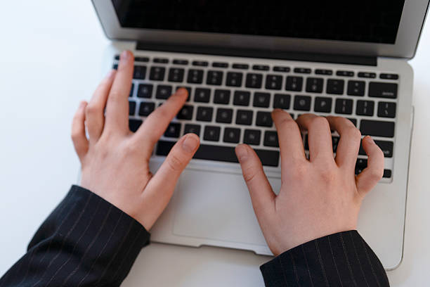 istock Hands typing on a laptop keyboard during a business meeting in a modern office setting at daytime, emphasizing productivity and focus on work tasks 2228081805