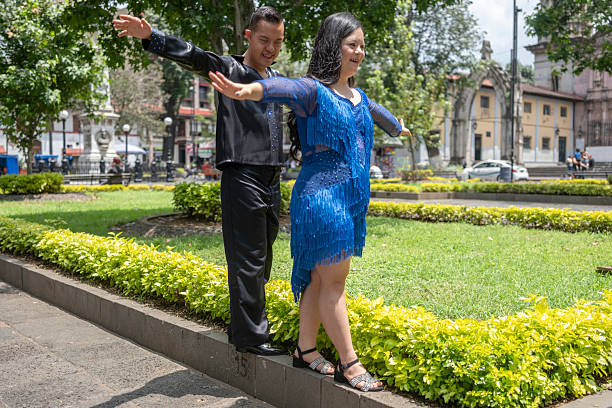 Buenos Aires, Argentina - July 31 2016: Rainy days in the neighborhood of La Boca. A couple dancing tango on the street.
