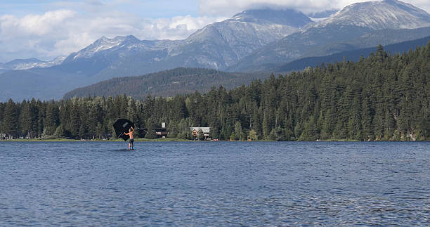 istock Young man wing foils on lake, Whistler 2228086956