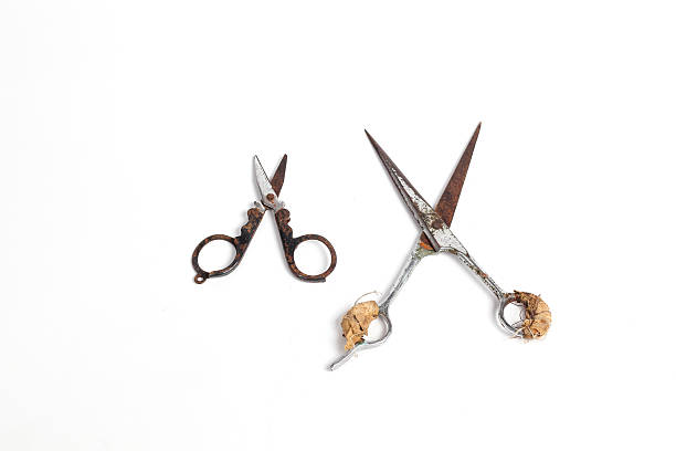 istock small scissors and barber scissors covered in rust wrapped in bandage isolated on white background 2228089163