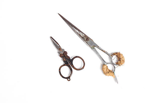 istock small scissors and barber scissors covered in rust wrapped in bandage isolated on white background 2228089172