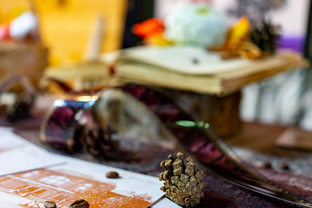 Vintage table setting with rustic ceramic cups, old keys, paper envelopes, and pine cones on a wooden surface.