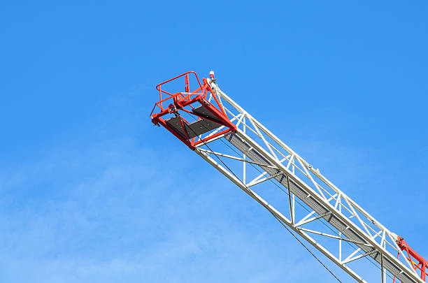 istock Closeup of tower crane boom with clear sky background in construction site 2228092776