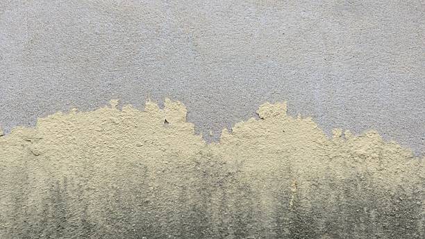 istock Peeling paint on the wall. Cream paint peeling on the wall. The old concrete wall has cracks and peeling. 2228093085