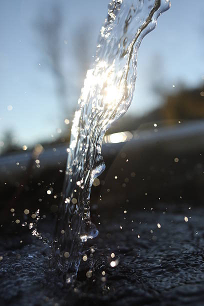 istock Stream of water is falling from a pipe, creating a beautiful 2228095167
