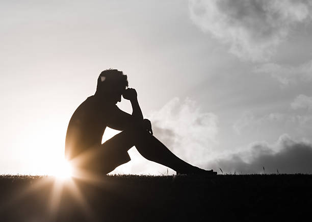 istock Sad man at sunset. Sadness, depression. 2228096560