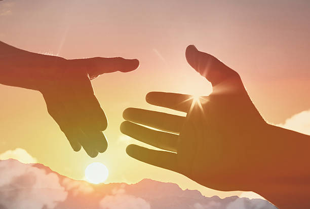 istock Giving a helping hand a on sunset background. 2228096820
