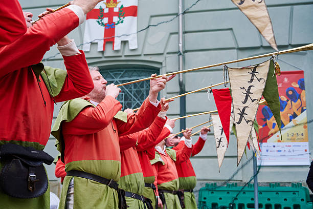 Ivrea, Italy - March 02, 2025: buglers in traditional costumes taking part to the grand historical parade of Ivrea Carnival featuring participants dressed in medieval costumes. They reenact various scenes from Ivrea's history, paying homage to the town's fight for independence.