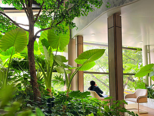 One person sitting by window of food court floor of shopping mall in downtown Bangkok, Thailand