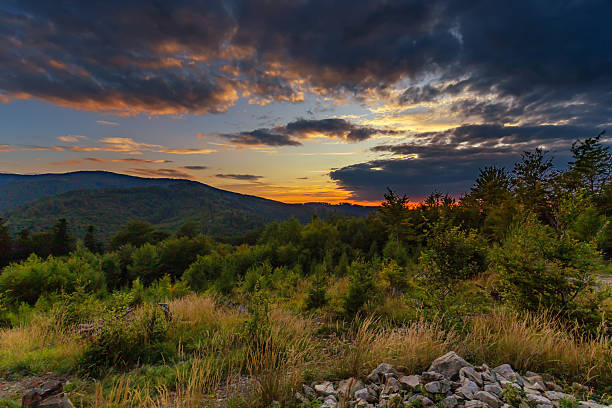 Mountain landscape in the Beskid Mountains (Kozia Góra, Stefanka, Poland). View of the colorful sky during a beautiful summer sunset. Background or wallpaper for your project.