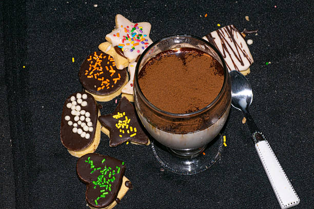 Coffee and milk in a glass , and cookies on the table