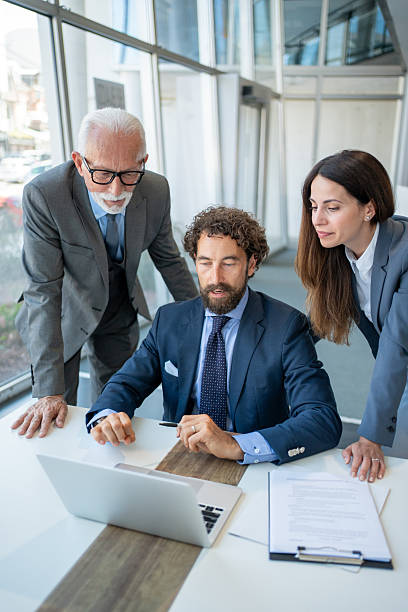 istock Business team working together on laptop in modern office 2228103640