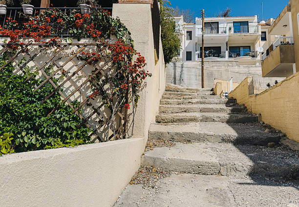 istock Old Mediterranean stone staircases surrounded by greenery and blue sky, traditional architecture 2228108127