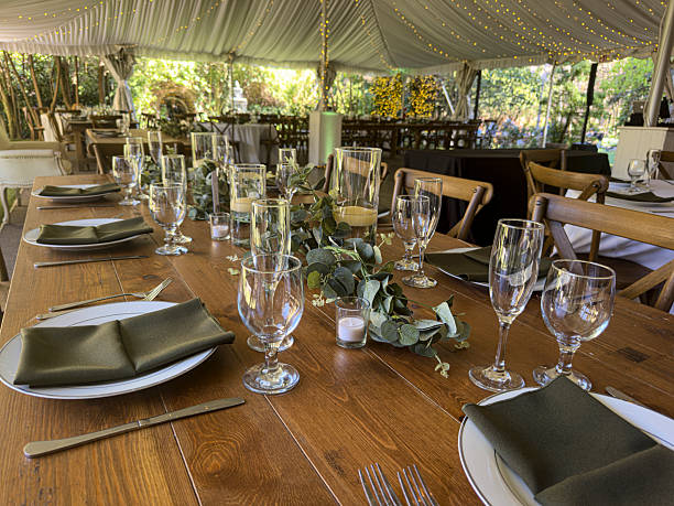 Elegant Empty Wedding Reception Table Settings in Rustic Tent Venue stock photo
