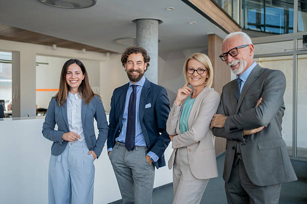 istock Smiling businesspeople posing together in modern office 2228109430