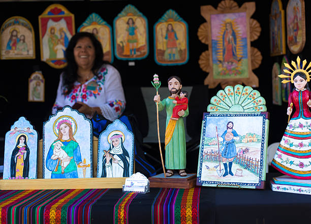Santa Fe, NM, USA - July 26, 2025: Artist Rose Vigil Price sells her traditional retablos (painted religious images on wood) and sculptures at the 2025 Spanish Market in Santa Fe, NM. Organized by the Spanish Colonial Arts Society, the annual Spanish Market includes about 250 artists and takes place outside on and around the historic Santa Fe Plaza.