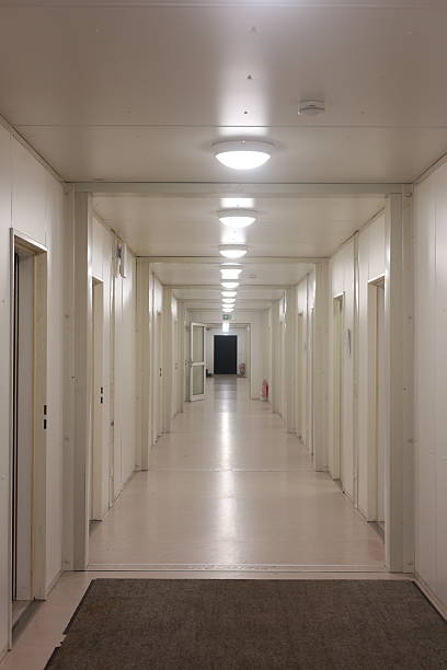 istock Long hallway with white walls and doors 2228110639