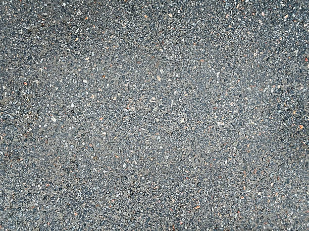 istock Asphalt surface background top view . Grainy road closeup. Dark gray grunge texture backdrop. 2228111281