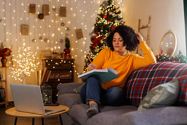 istock Lounging on the sofa and writing in her diary 2228116184
