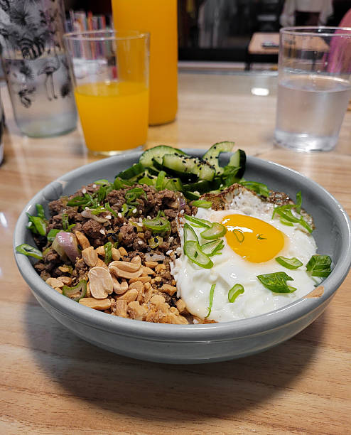 Asian Rice Bowl with Ground Beef, Fried Egg, Peanuts and Vegetables