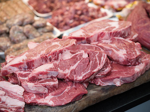 istock Raw beef steak on a white plate in a restaurant setting. Chef cutting fresh meat before cooking. 2228120216