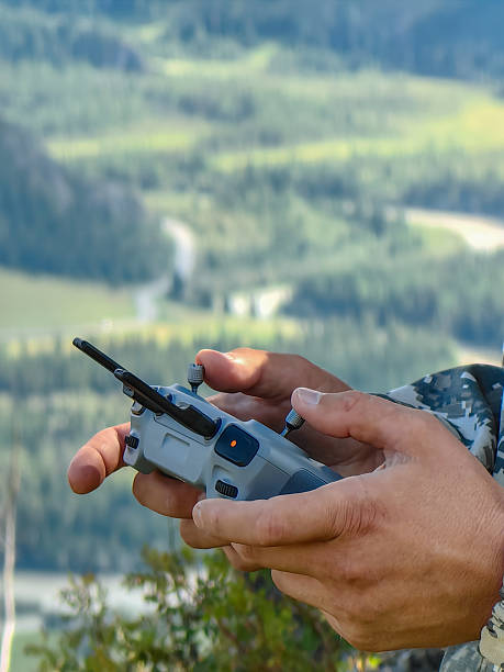 istock Hands controlling a drone with a beautiful mountain landscape in the background. 2228125110
