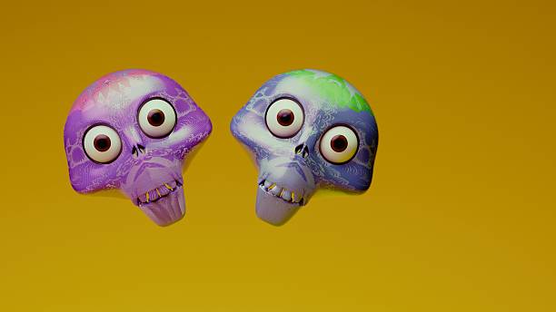 Two 3D ornamental skull figurines with large round eyes and intricate lace-like patterns stand side by side in a centered frontal view against a solid orange backdrop.