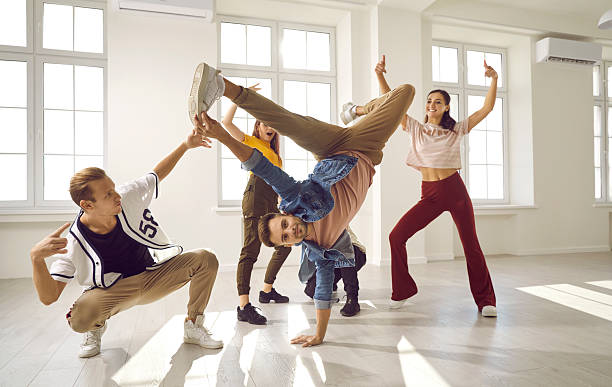 istock Energetic male dancer has fun with his dance group doing elements of breakdance movements. 2228129784