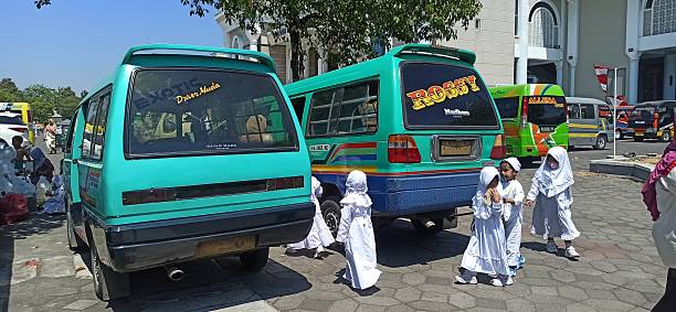 Surabaya, Indonesia – July 30, 2025: A classic Surabaya minibus serves as reliable school transportation, reflecting local culture and community-oriented solutions for students’ daily commute